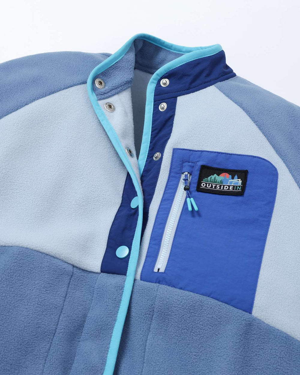Lightweight fleece jacket close-up: snap-button placket, zip front, and chest logo patch