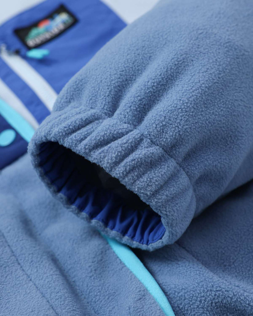 Lightweight fleece jacket sleeve cuff with elastic hem and contrasting dark inner facing