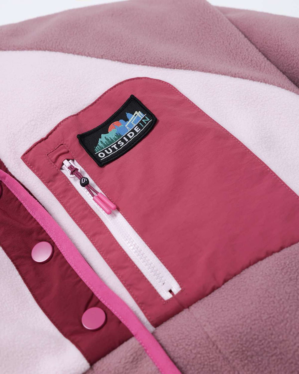 Fleece jacket chest pocket with patch logo and white zipper detail