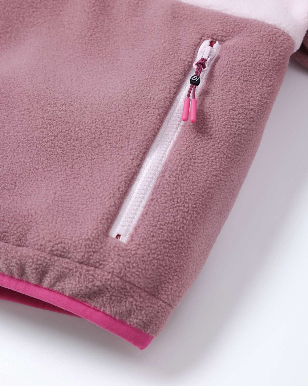 Fleece jacket side zipper with pink pull tab and white zipper tape