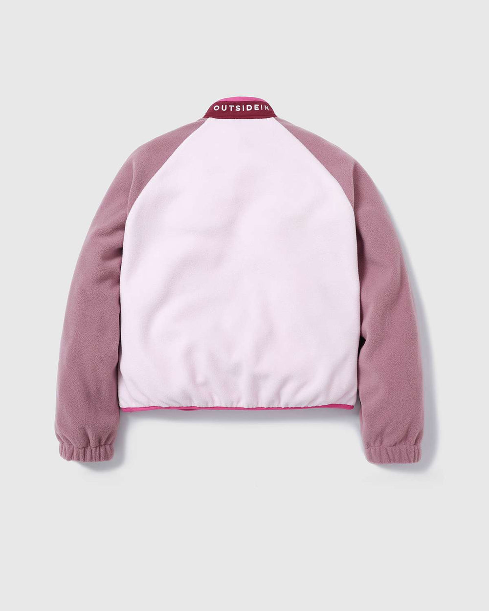 Color-block fleece jacket back view with pink OutsideIn logo at collar