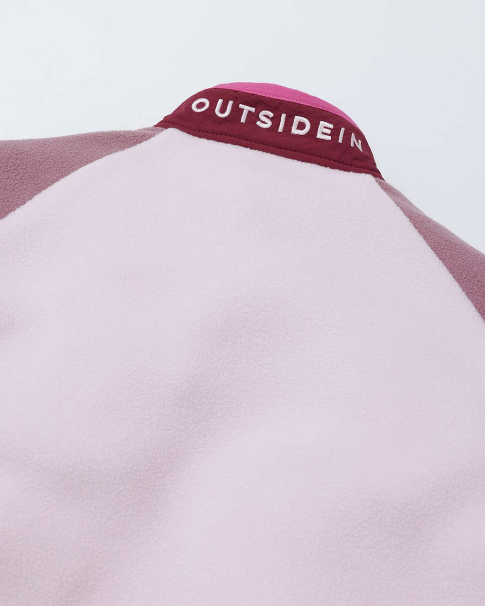 Fleece jacket collar label with OutsideIn on maroon-trim neckline