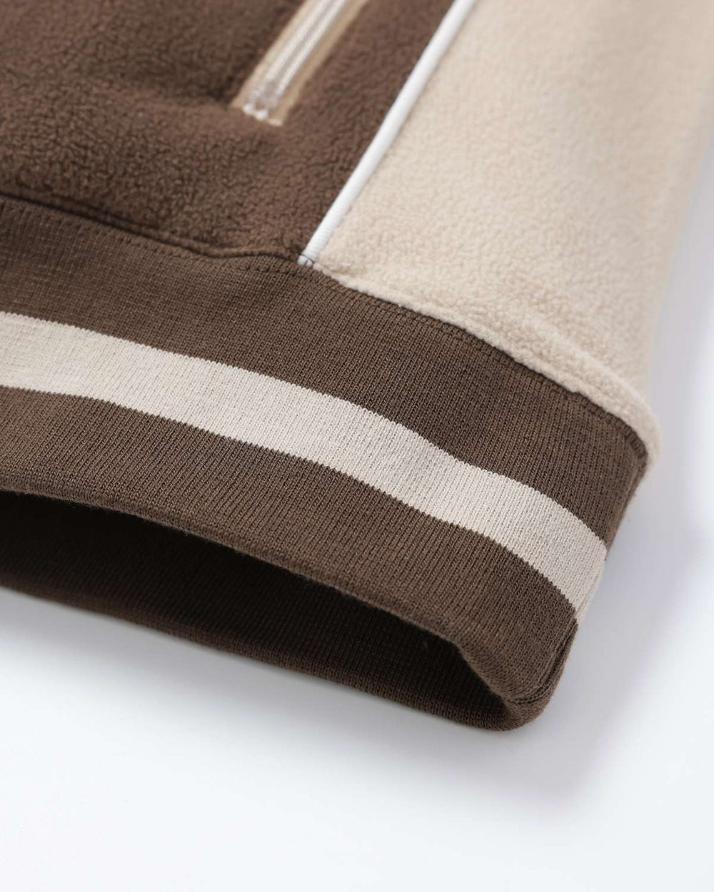 Brown fleece hem with cream side panel and ribbed hem band in two-tone stripes