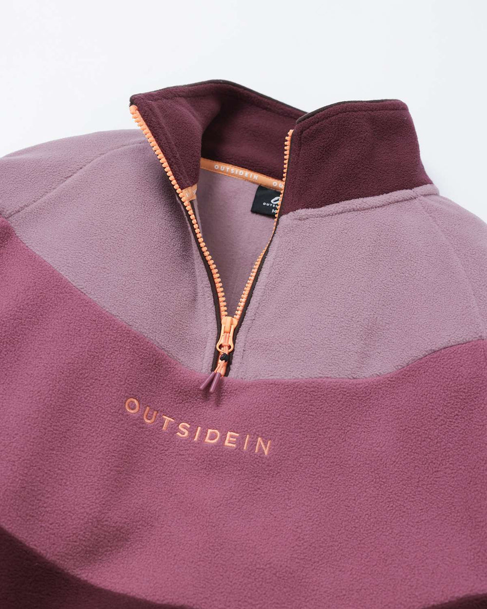 Burgundy quarter-zip fleece with orange-gold zipper and contrasting inner collar