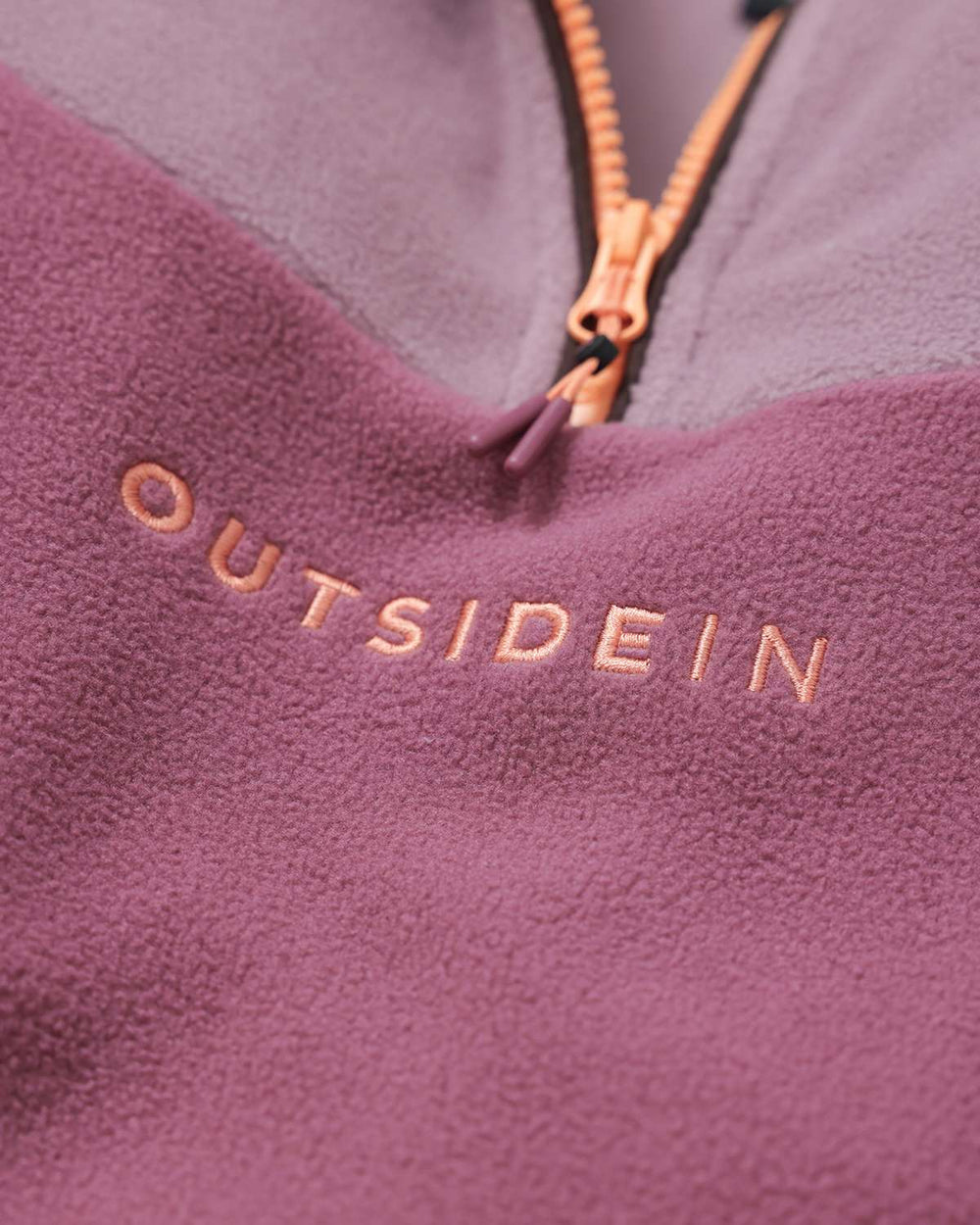 Burgundy fleece with OutsideIn logo embroidery and orange-gold half-zip