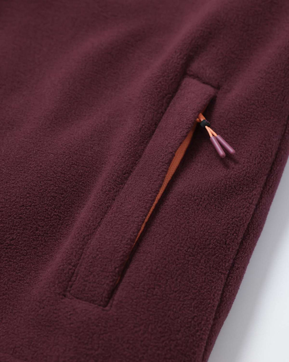 Burgundy fleece with zip pocket detail and contrast inner fabric at side seam