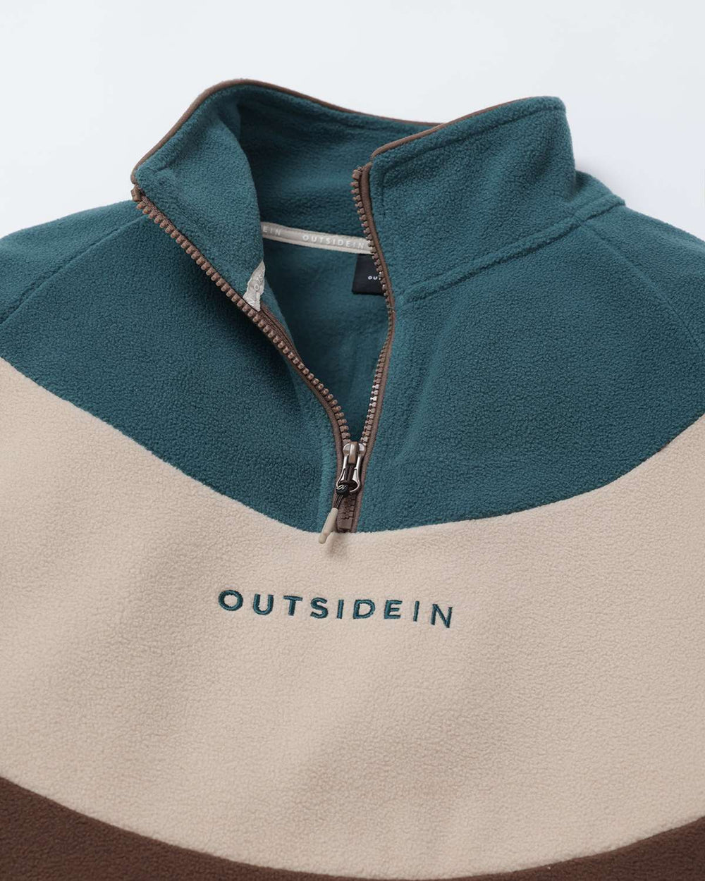 Teal and cream fleece zip-up with stand collar; brown trim and OutsideIn logo