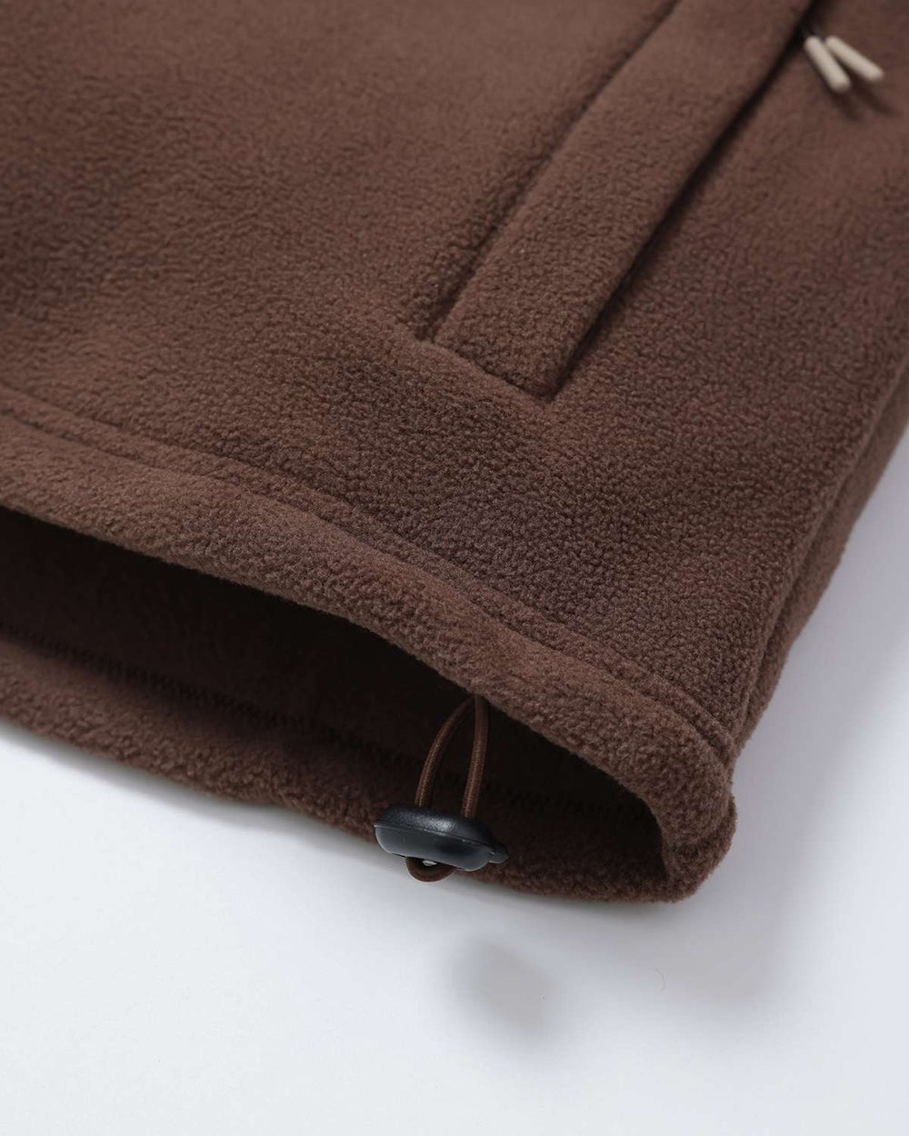 Brown fleece hem with toggle closure and stitched pocket seam detail