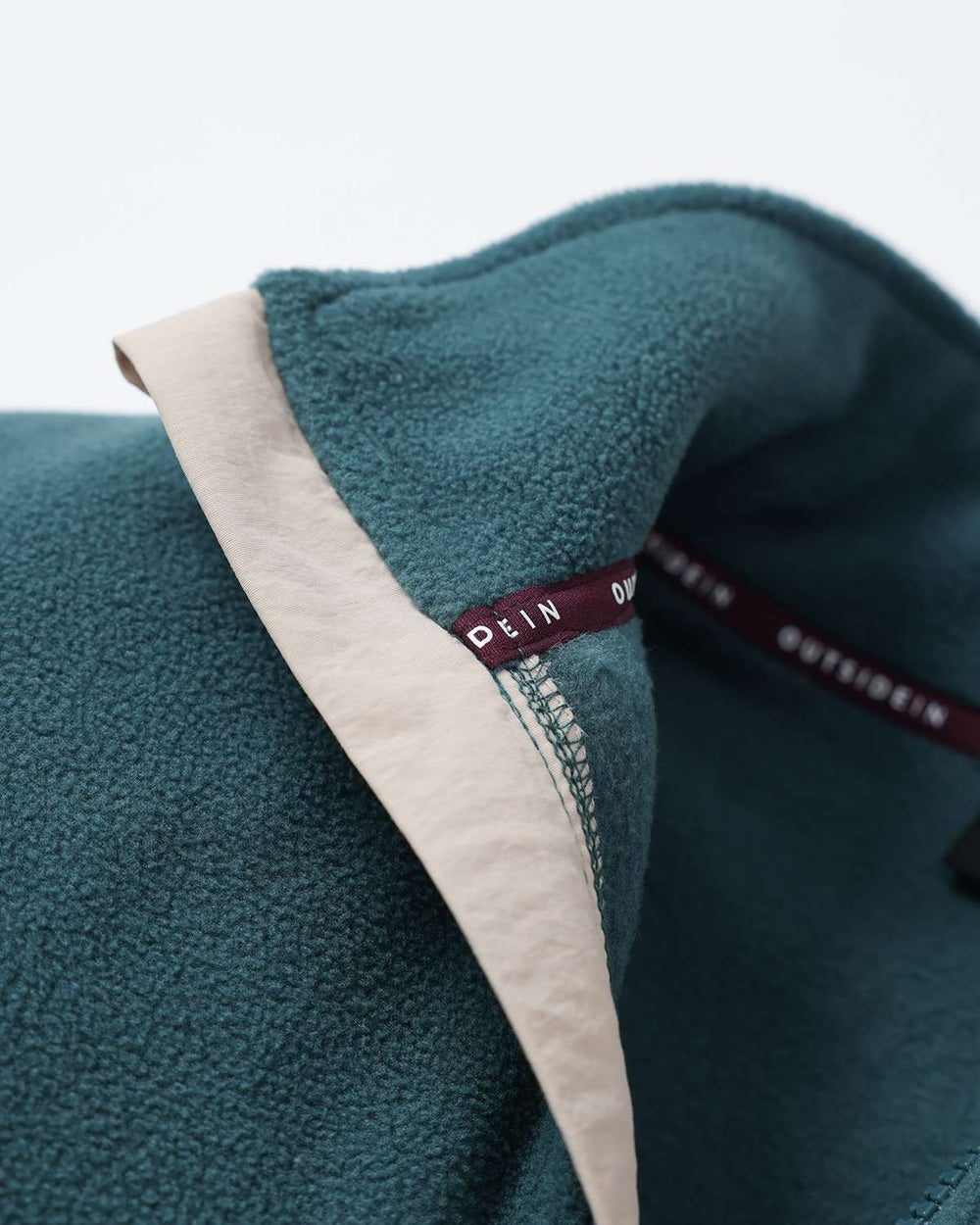 Teal microfleece collar trim with interior label and contrasting fabric edge