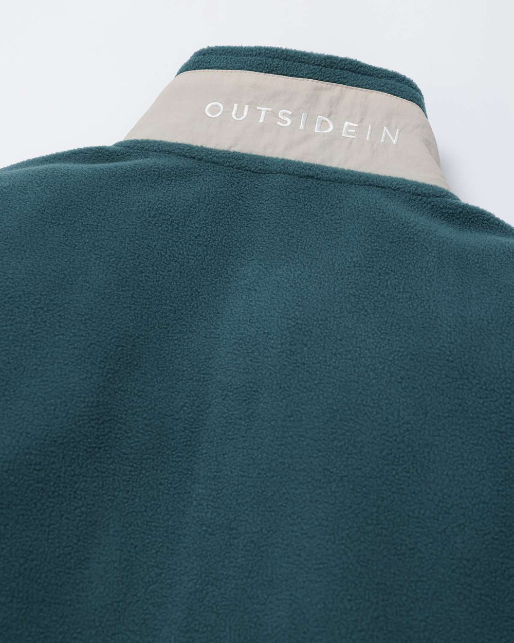 Teal microfleece pullover showing OutsideIn label at inner collar