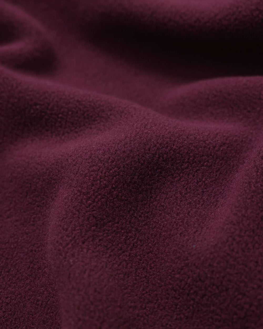 Burgundy microfleece fabric close-up with soft textured pile