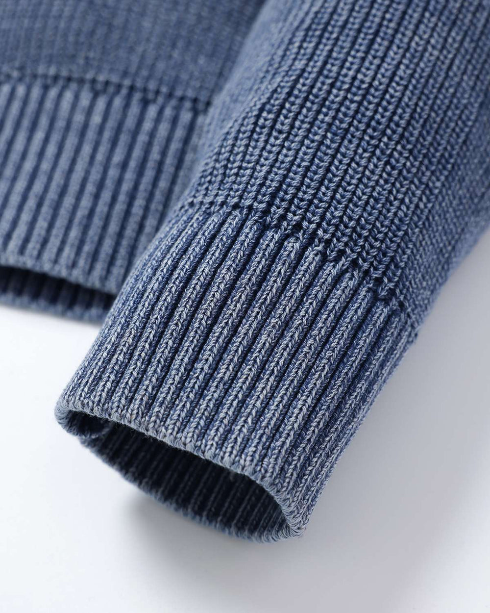 Blue rib knit sweater cuff with ribbing and rolled hem edge