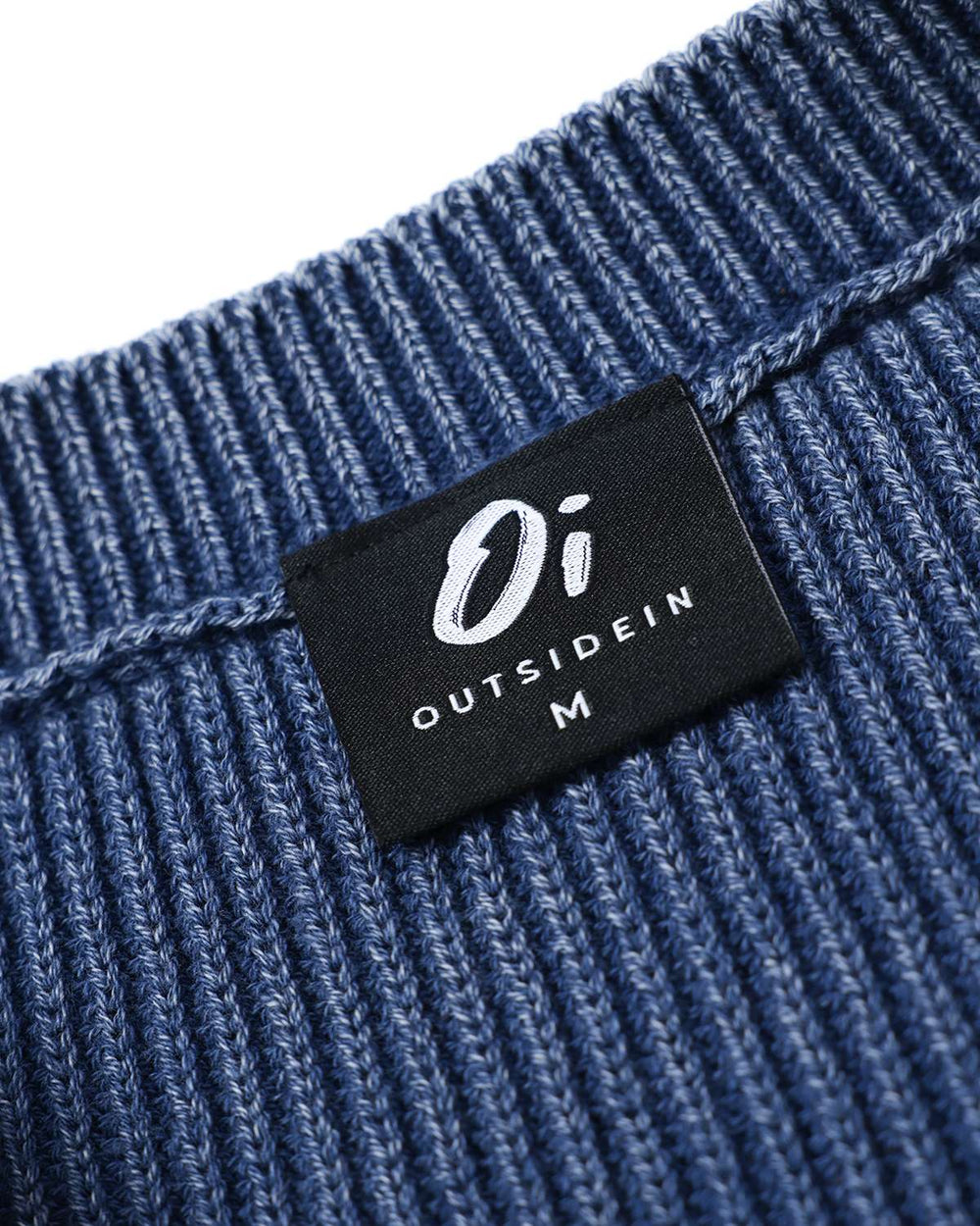 Blue rib knit sweater neckline with black brand label patch