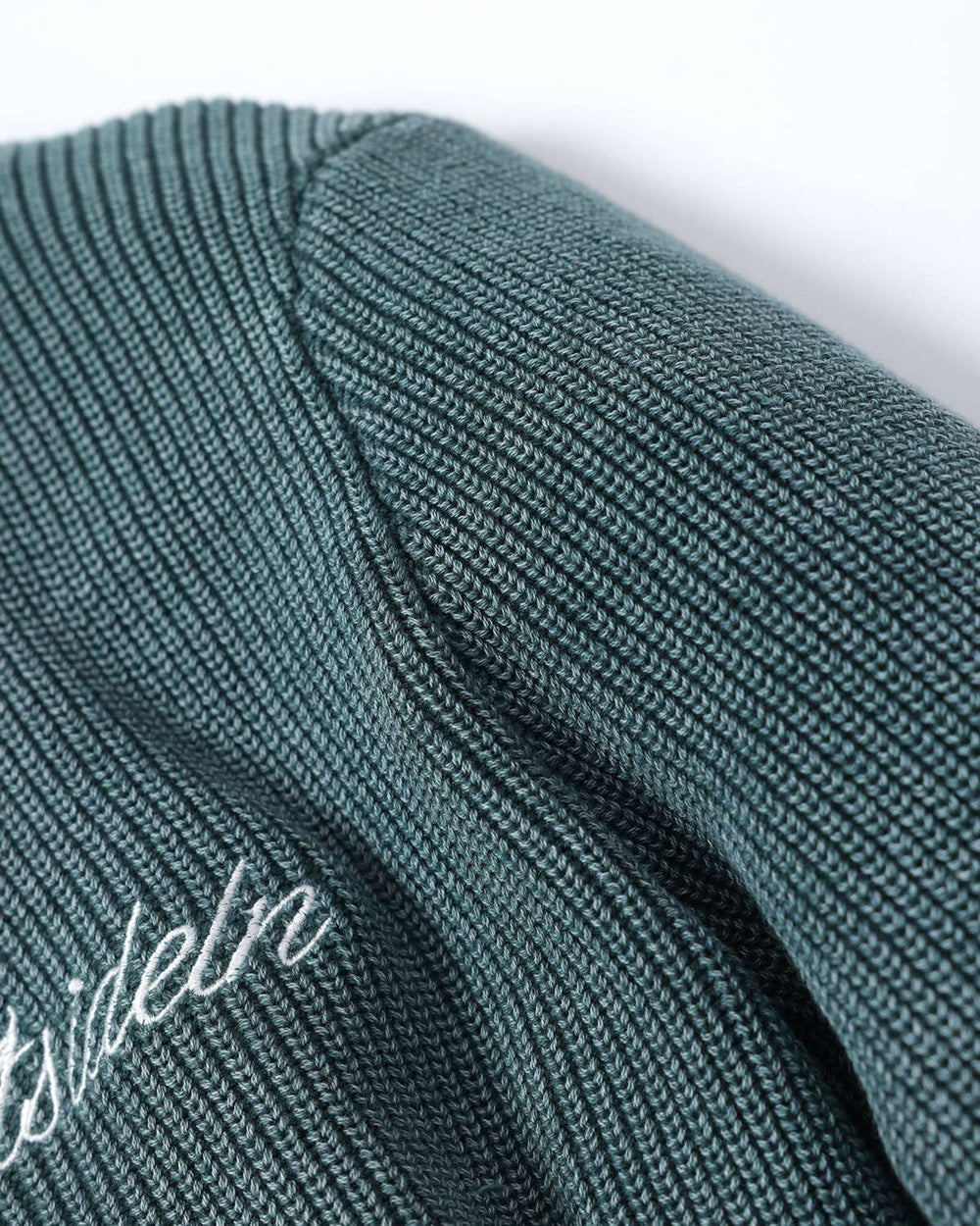 Fern green rib knit sweater shoulder seam detail with partial logo