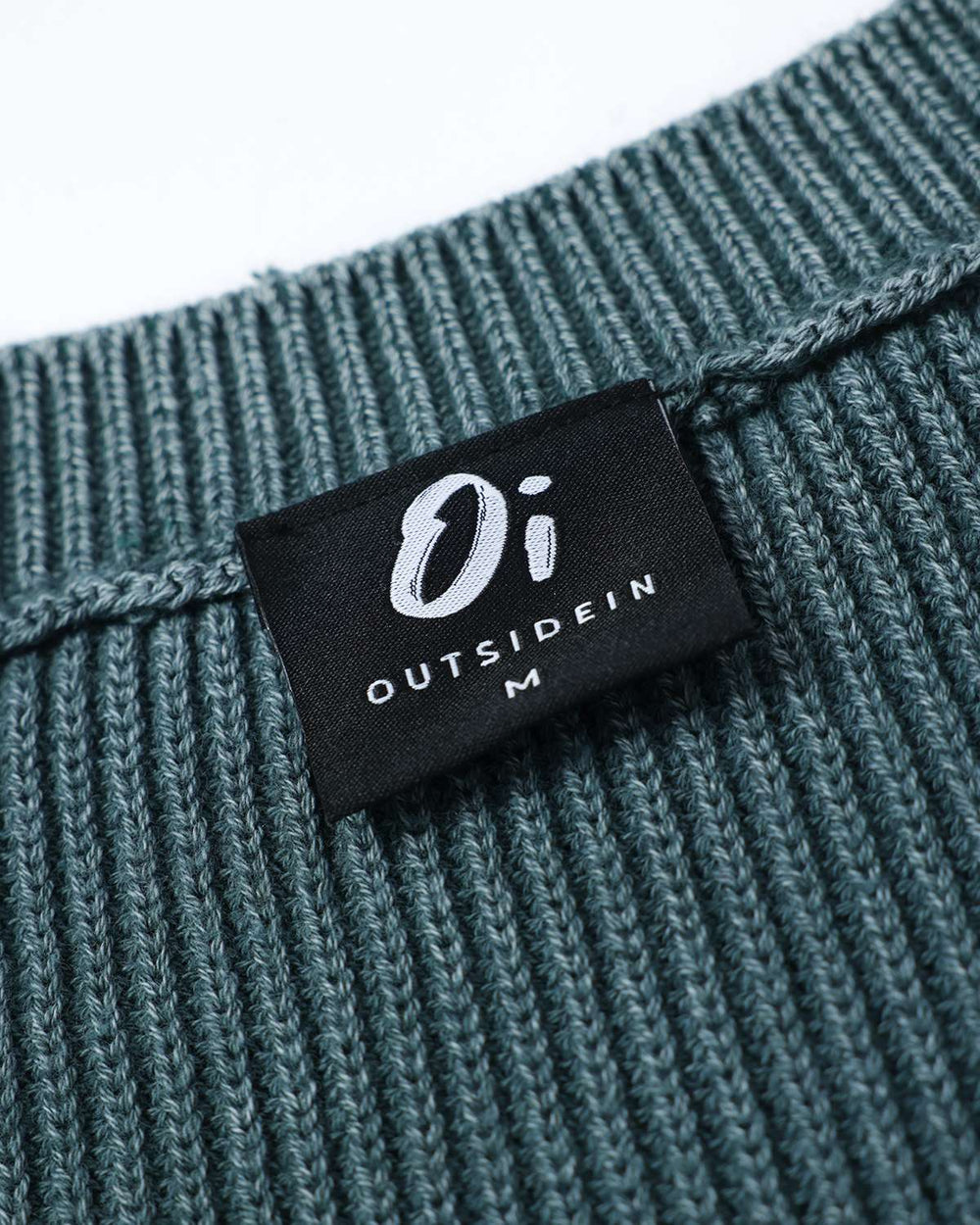 Fern green rib knit sweater neck label with O1 Outside In mark