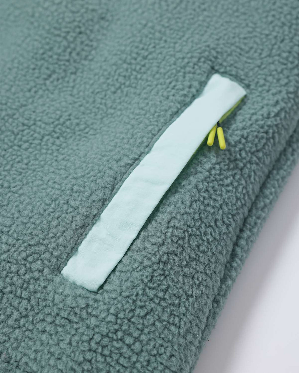 Evergreen fleece front panel detail with white side placket and zipper pocket