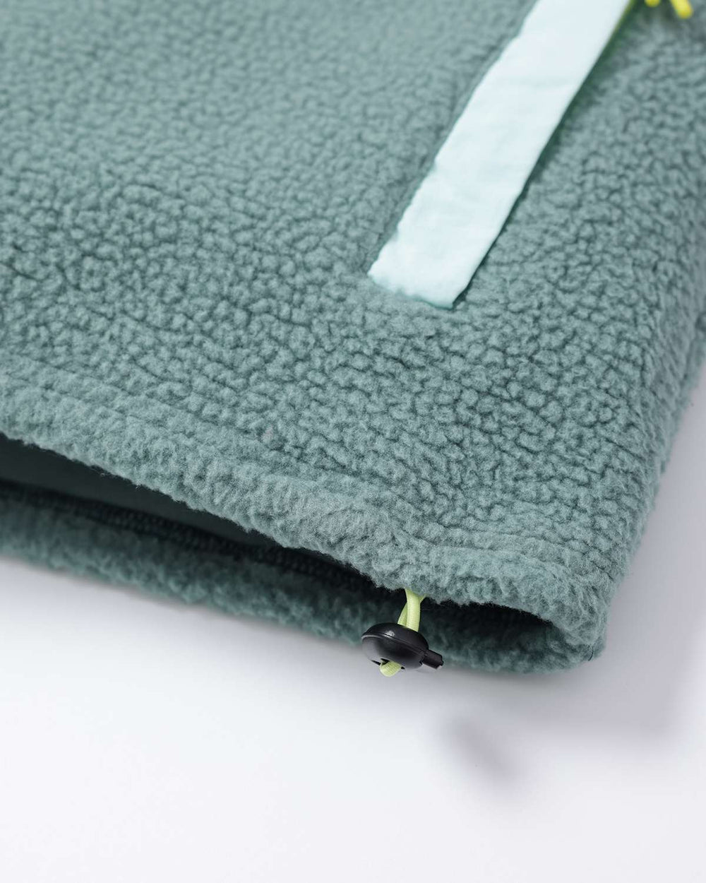 Evergreen fleece hem with zipper pull detail and white stripe accent