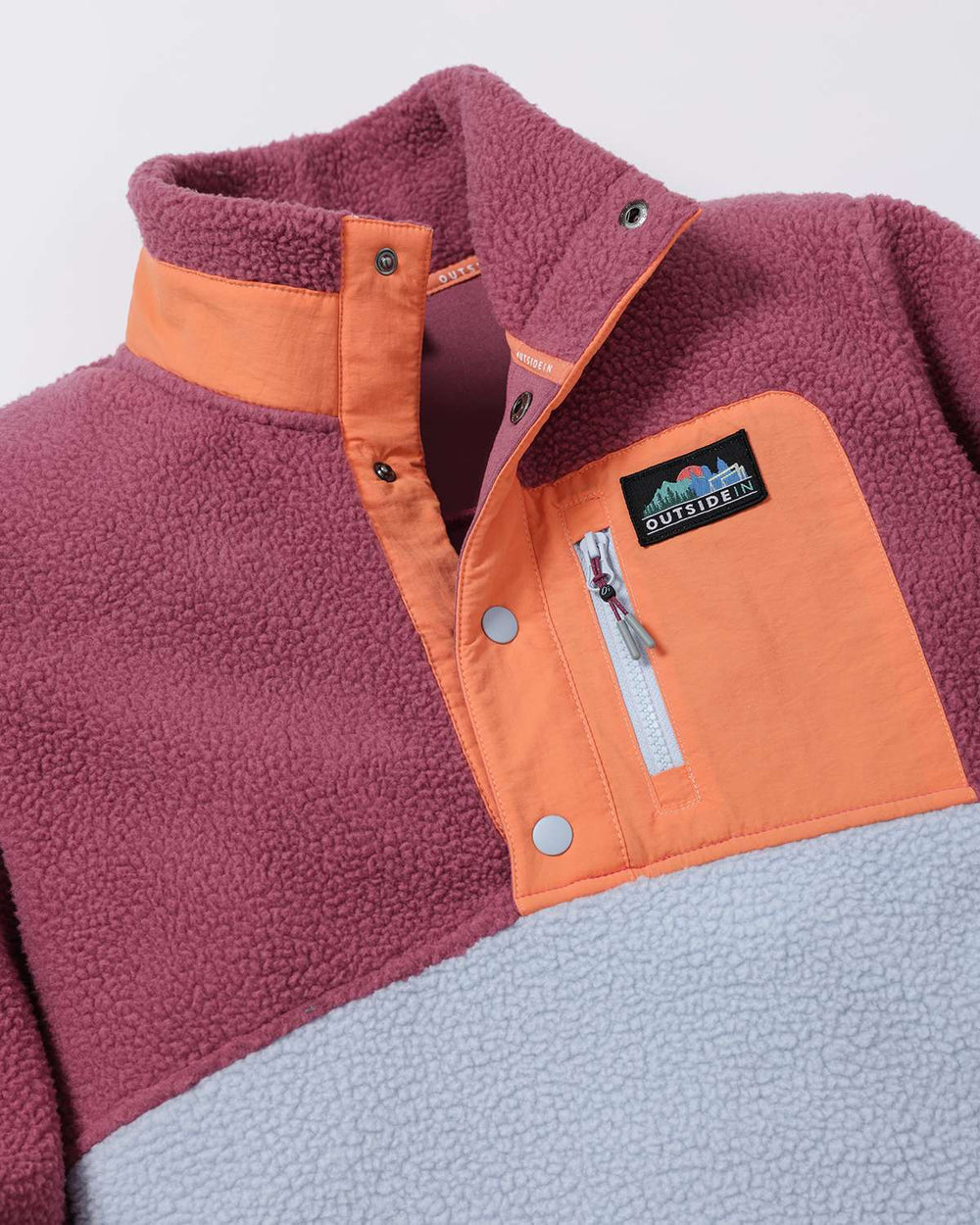 Purple sherpa fleece quarter-zip style jacket with orange front yoke and snaps.