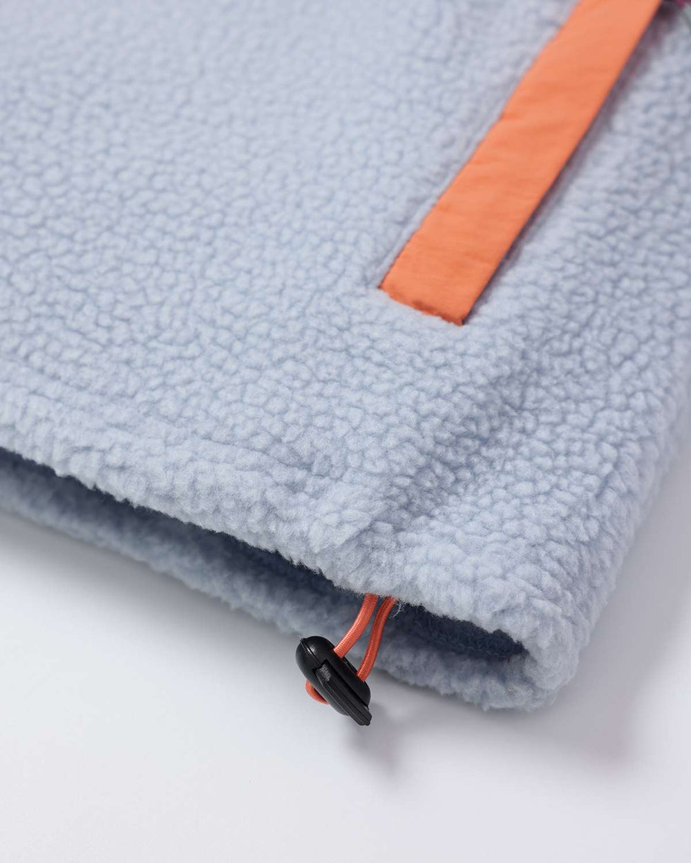 Light blue fleece hem with orange corner detail and black drawcord adjuster.