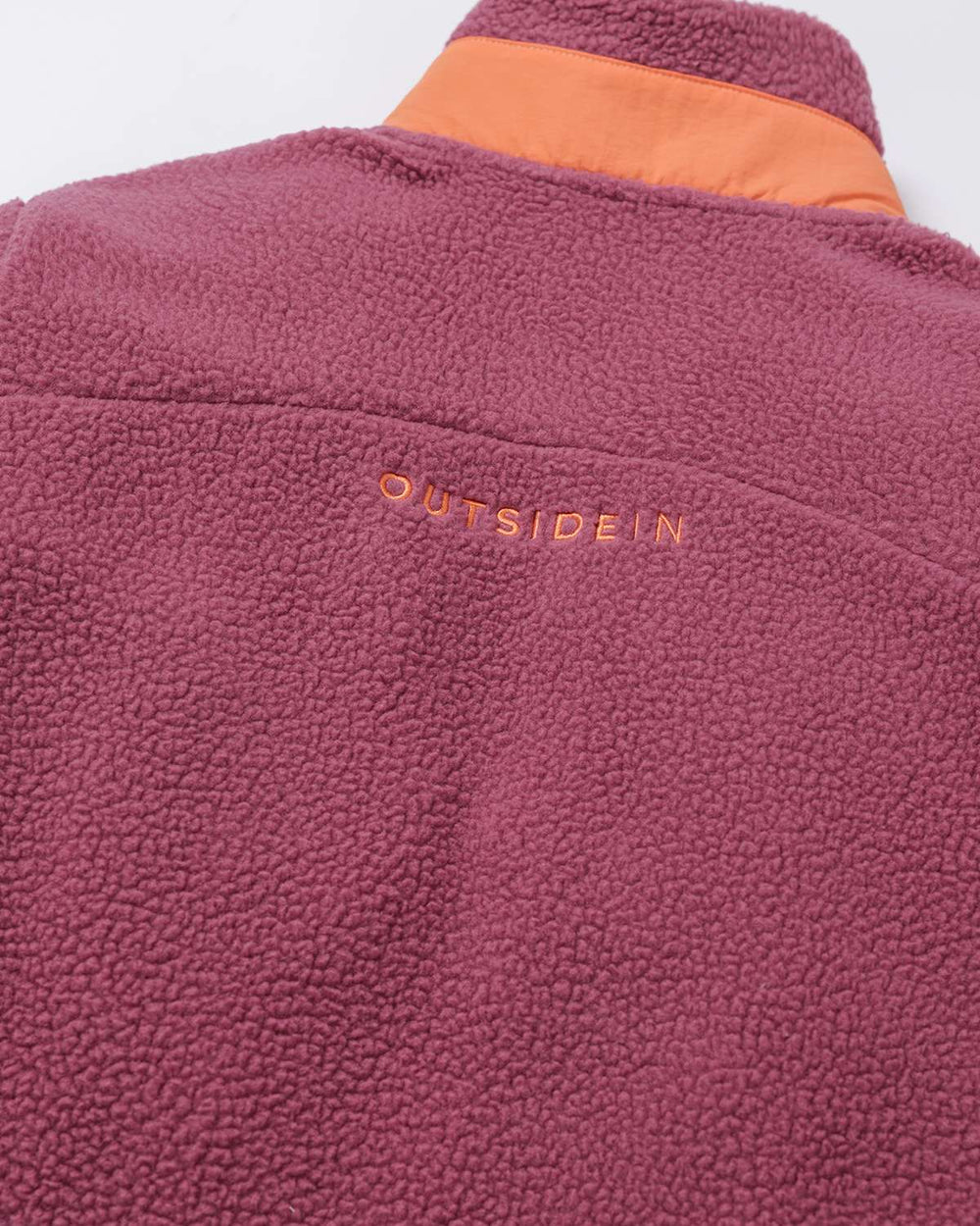 Purple back fleece with embroidered OutsideIn word mark and textured sherpa surface.
