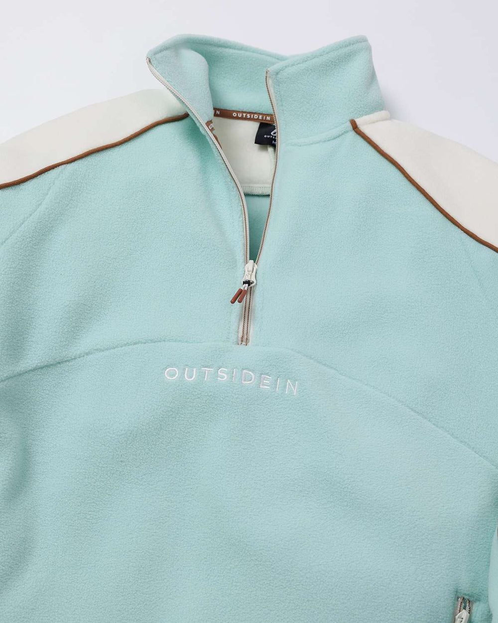 Light teal sports fleece quarter-zip with contrast brown piping and knit stand collar