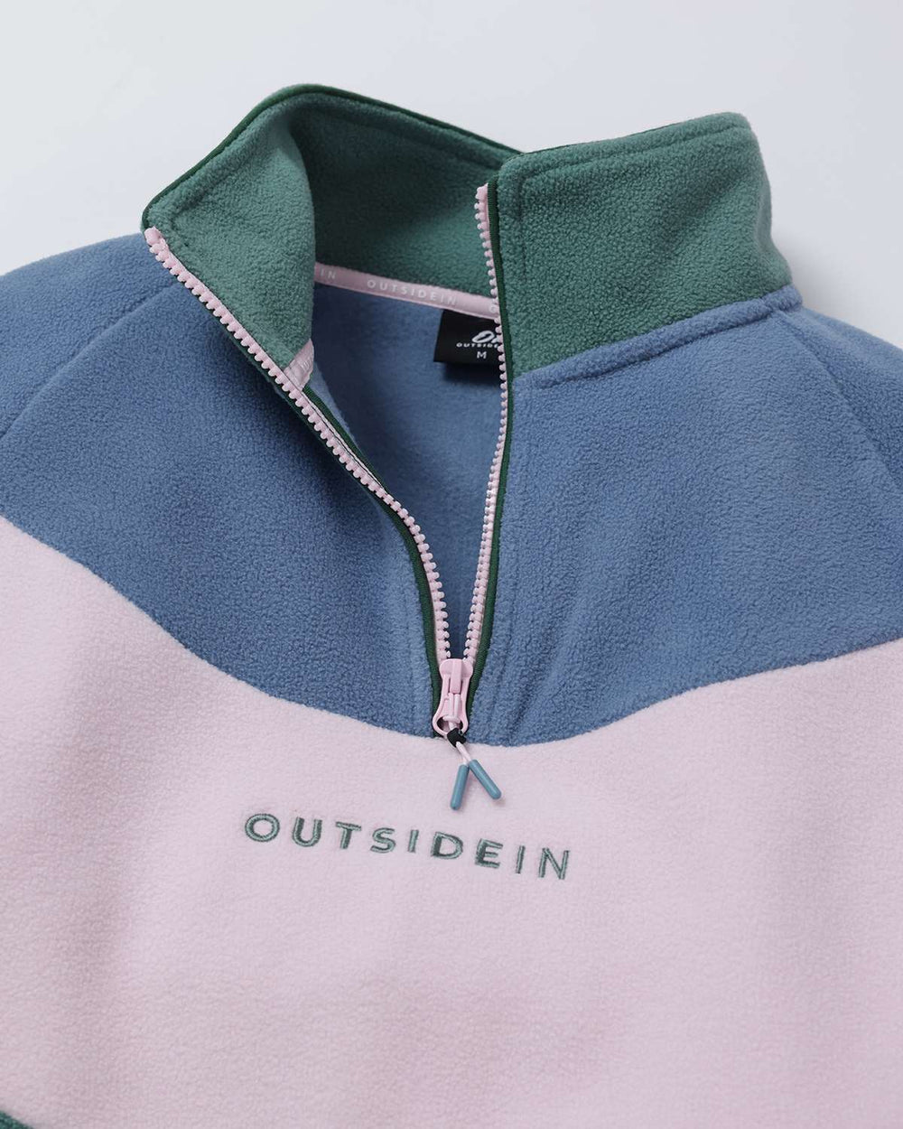 Colorblock fleece quarter-zip jacket close-up, stand collar and logo embroidery in green blue pink