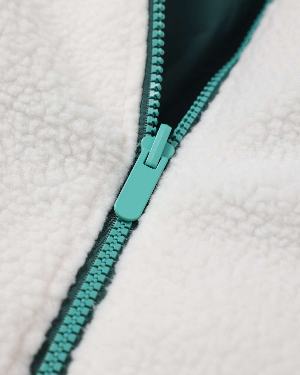 Teal reversible fleece jacket with turquoise zipper and pull tab