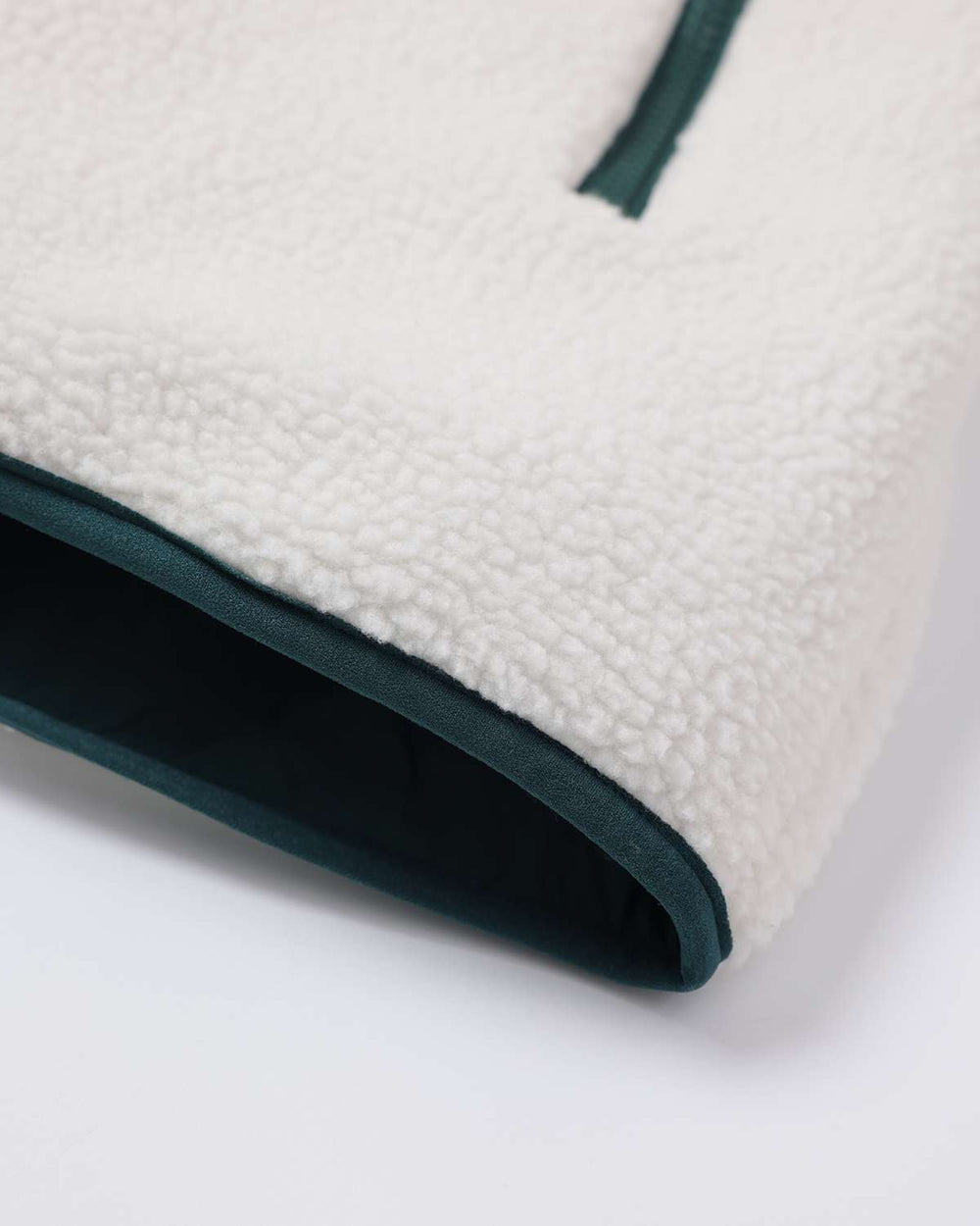 White sherpa fleece jacket with dark teal bound hem opening