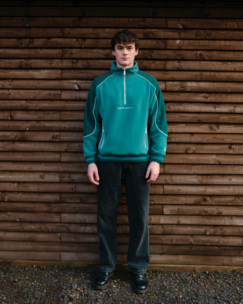 Model wearing OutsideIn pine green unisex sports fleece