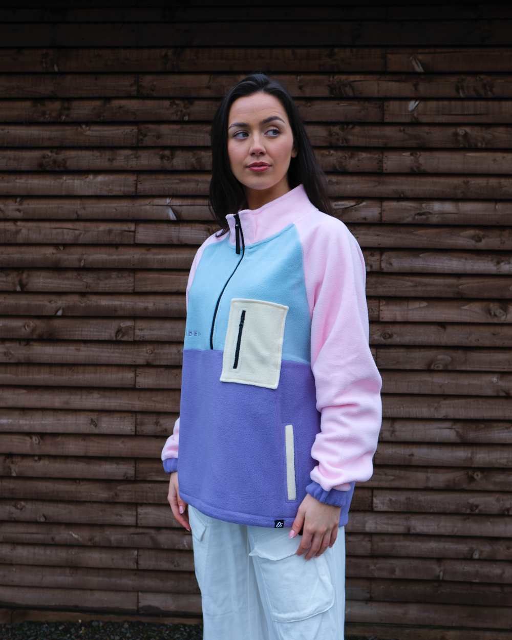 Model wearing Petal Bloom Pocket Fleece 1/2 zip, lightweight outdoor fleece jacket.