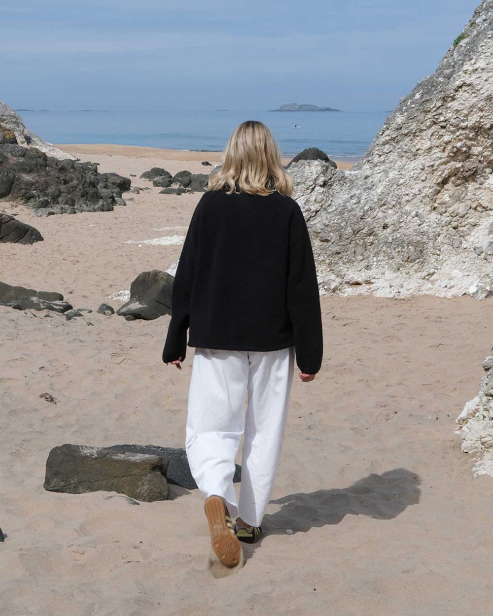 Back view of Model wearing OutsideIn Black Teddy Quarter Zip Fleece