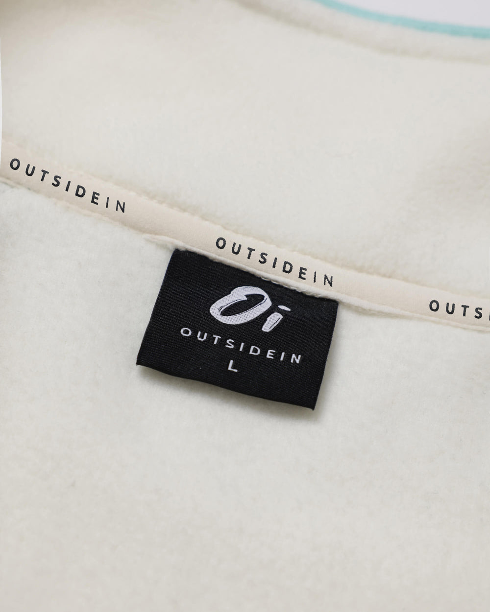 Close up of OutsideIn Brown Cream Canyon Fleece Neck label