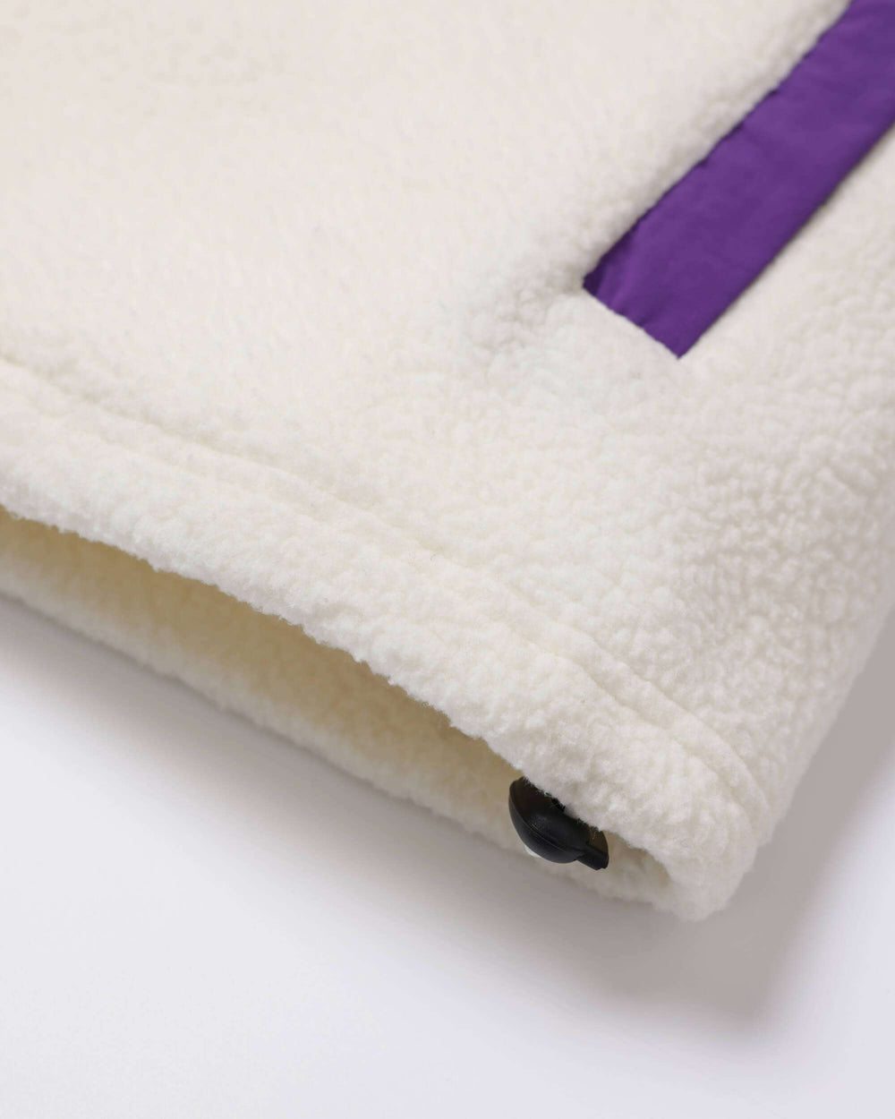 Borg fleece jacket hem with snap button; white body and purple sleeve cuff