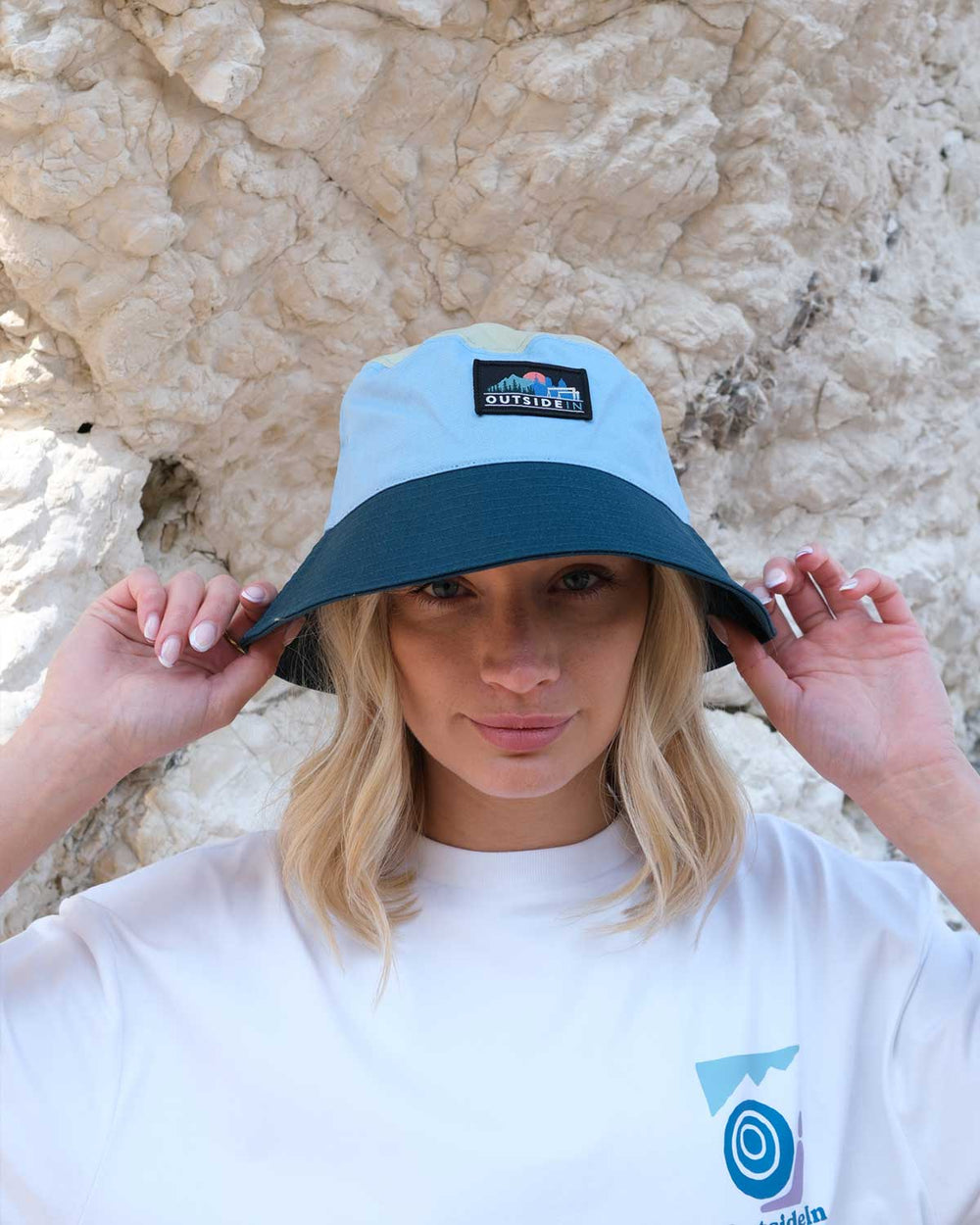 Model wearing blue OutsideIn Horizon Bucket Hat