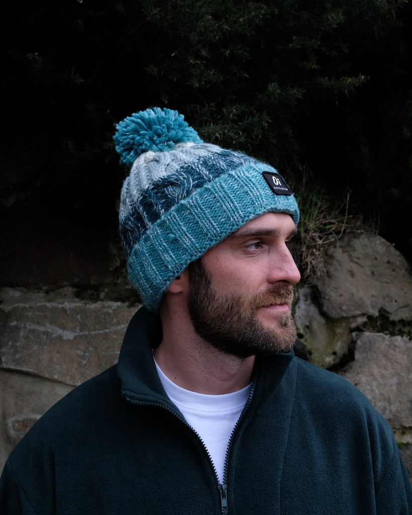 Sea Foam Pom hat with partial faux shearling lining and acrylic knit