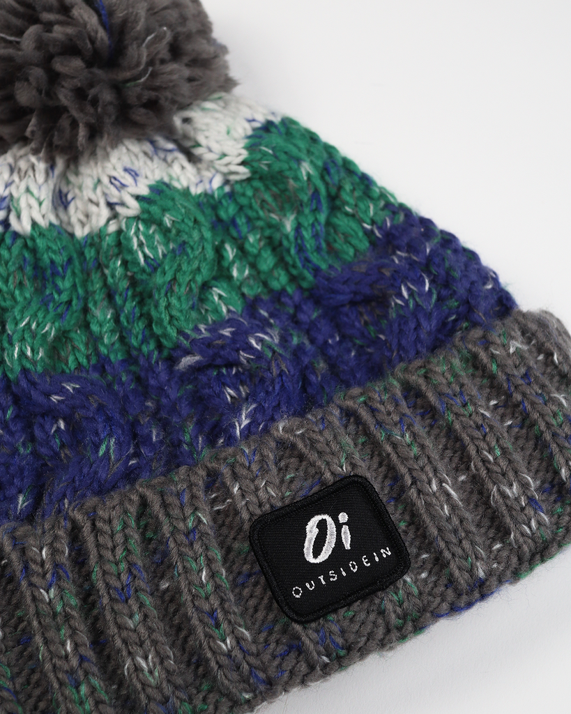 Pom hat in Wild Atlantic colour featuring soft faux shearling base lining and 100% acrylic yarn