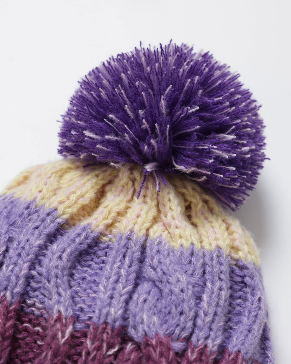 Close-up of a OutsideIn pom-pom hat 