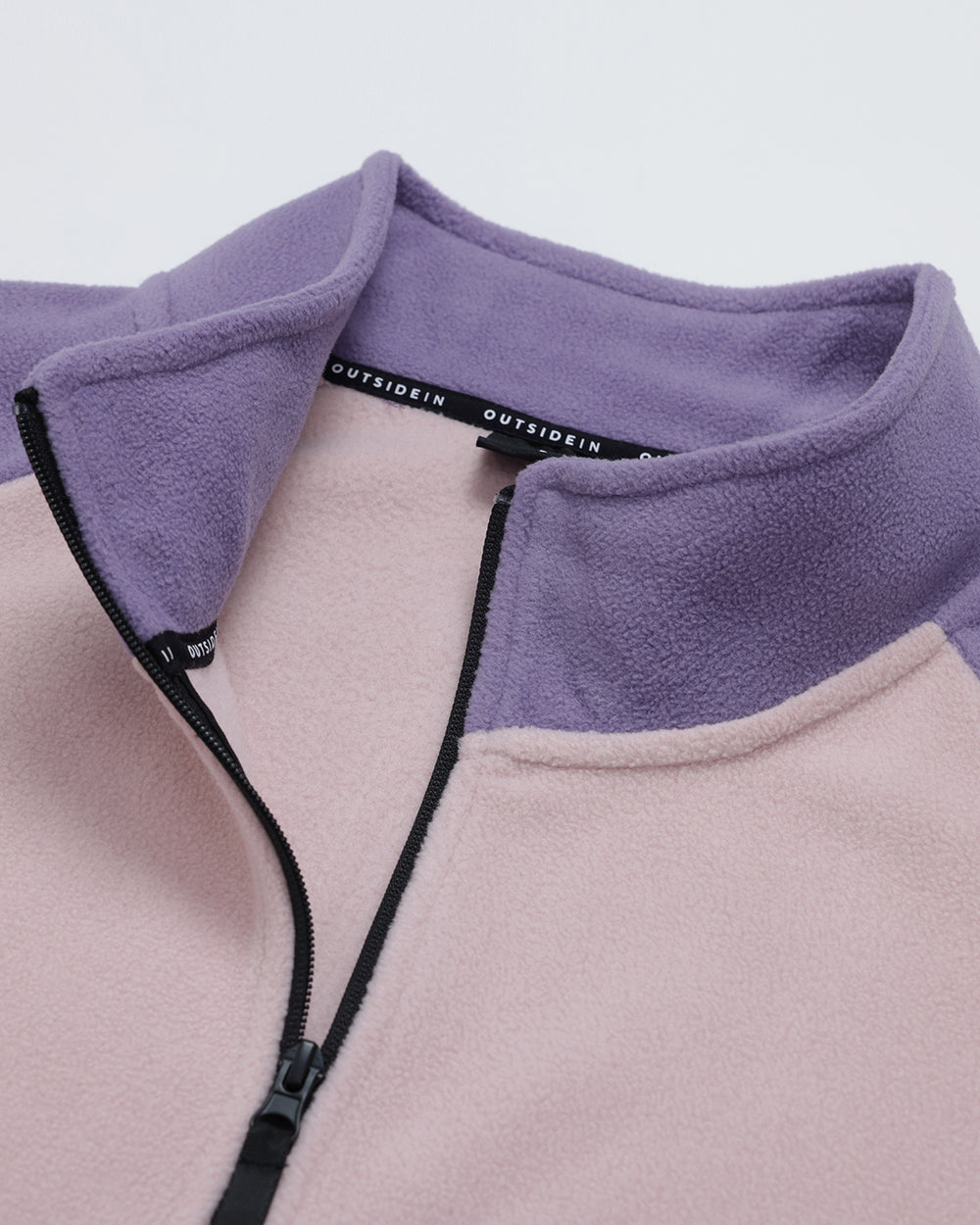 Close-up of a Wild Mulberry Pocket Fleece, outdoor fleece jacket with 1/2 zip design on a light white background.