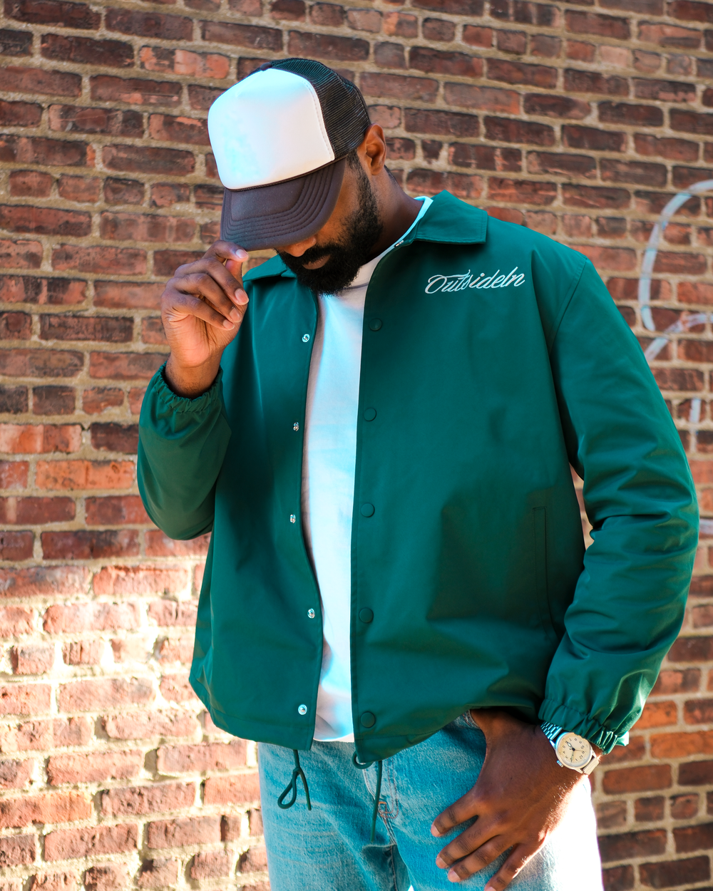 Model wearing Outside In Pine coach jacket outdoors