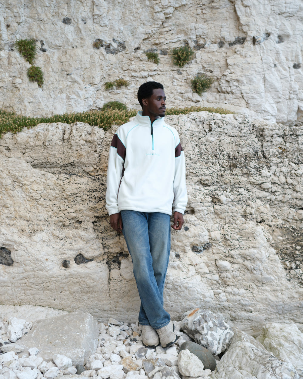 Man wearing OutsideIn Cream Canyon Quarter Zip Fleece with Brown Panels and Blue Piping