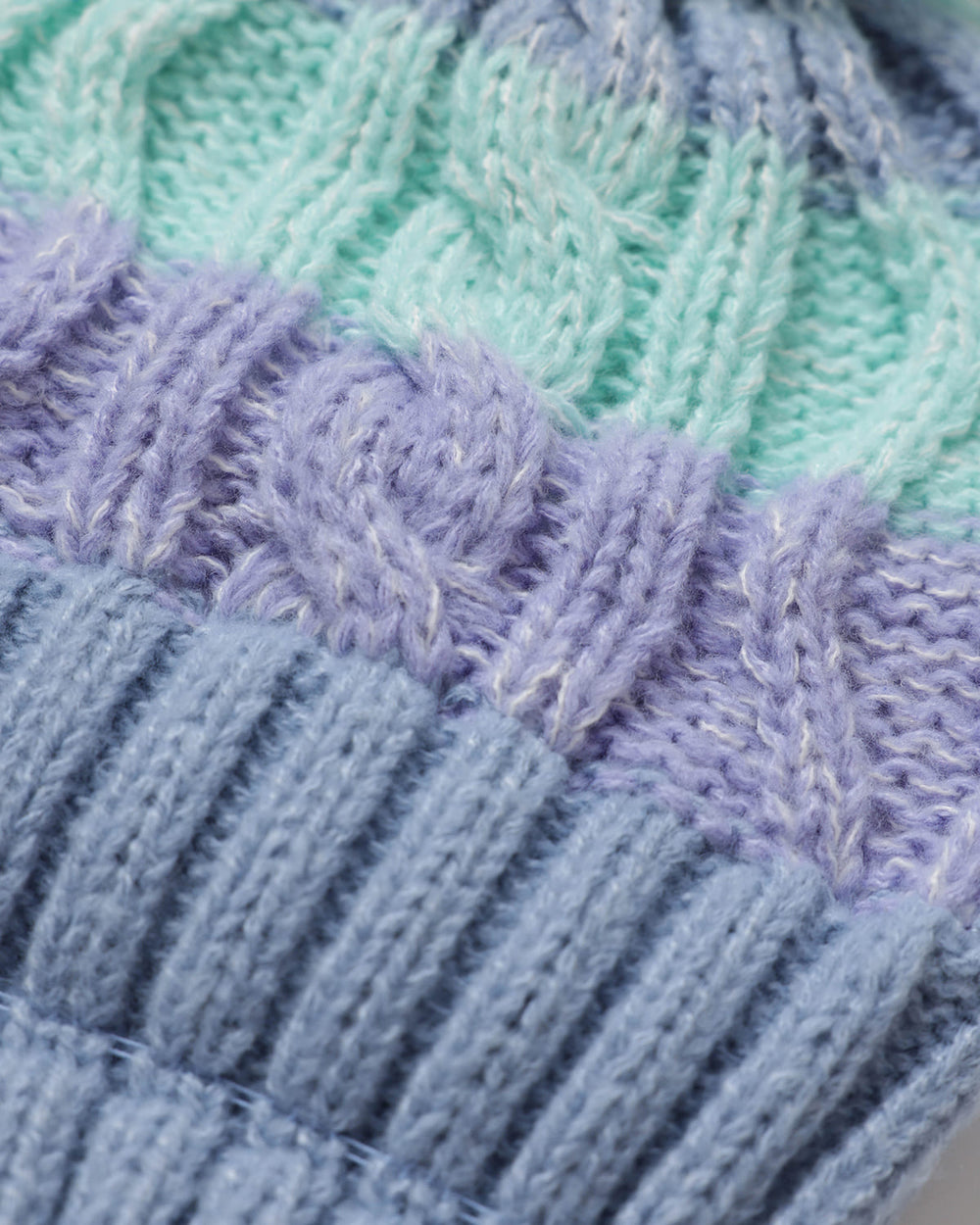 Close-up of a OutsideIn knitted textile pom pom hat