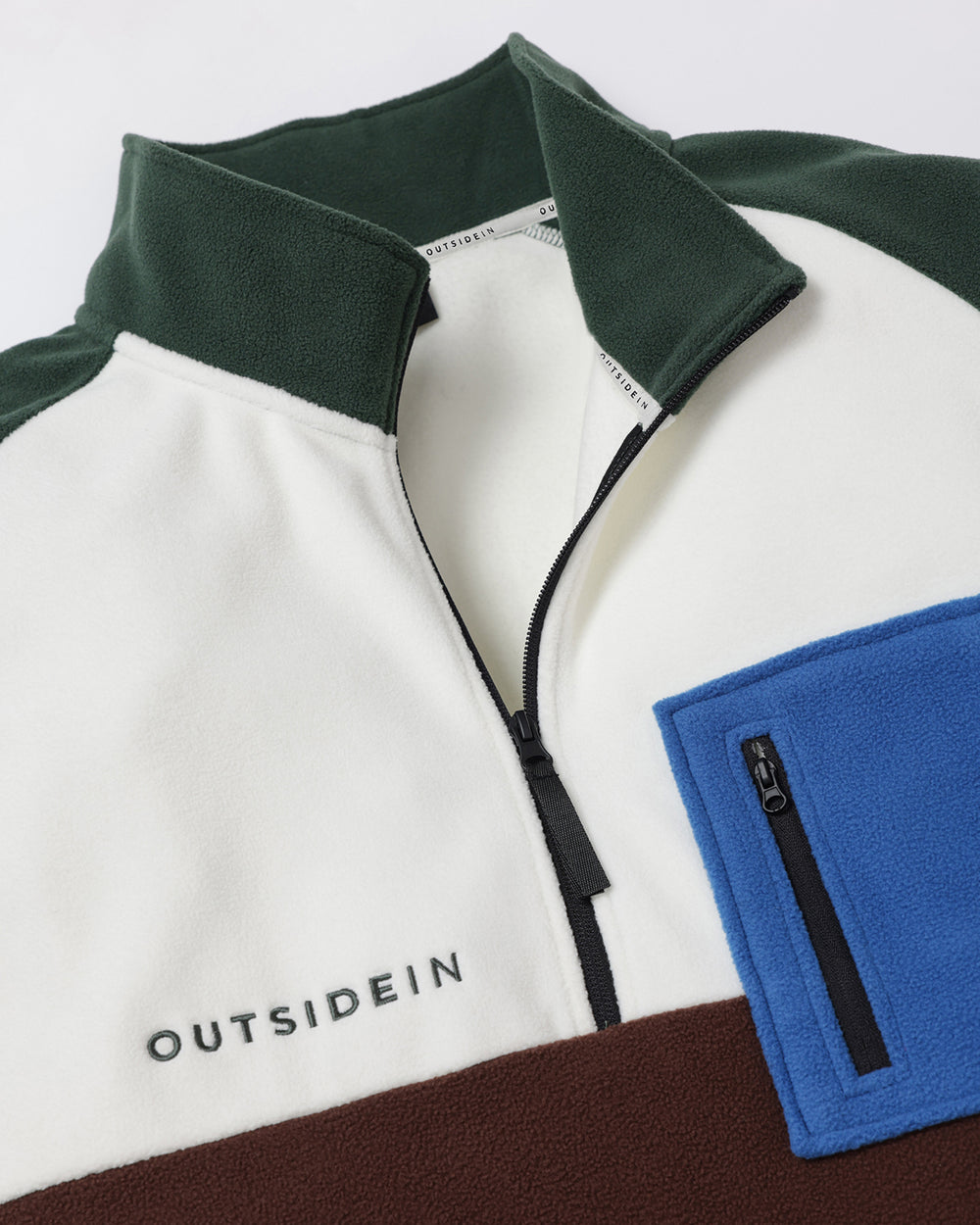 Close up of OutsideIn Green Brown Signature Pocket Fleece Flat lay