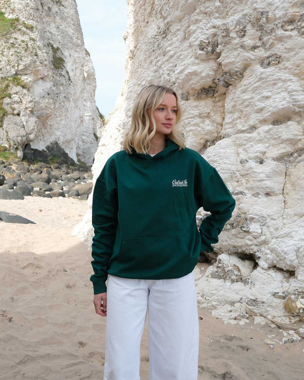 Model wearing green OutsideIn Causeway Pine Hoodie 