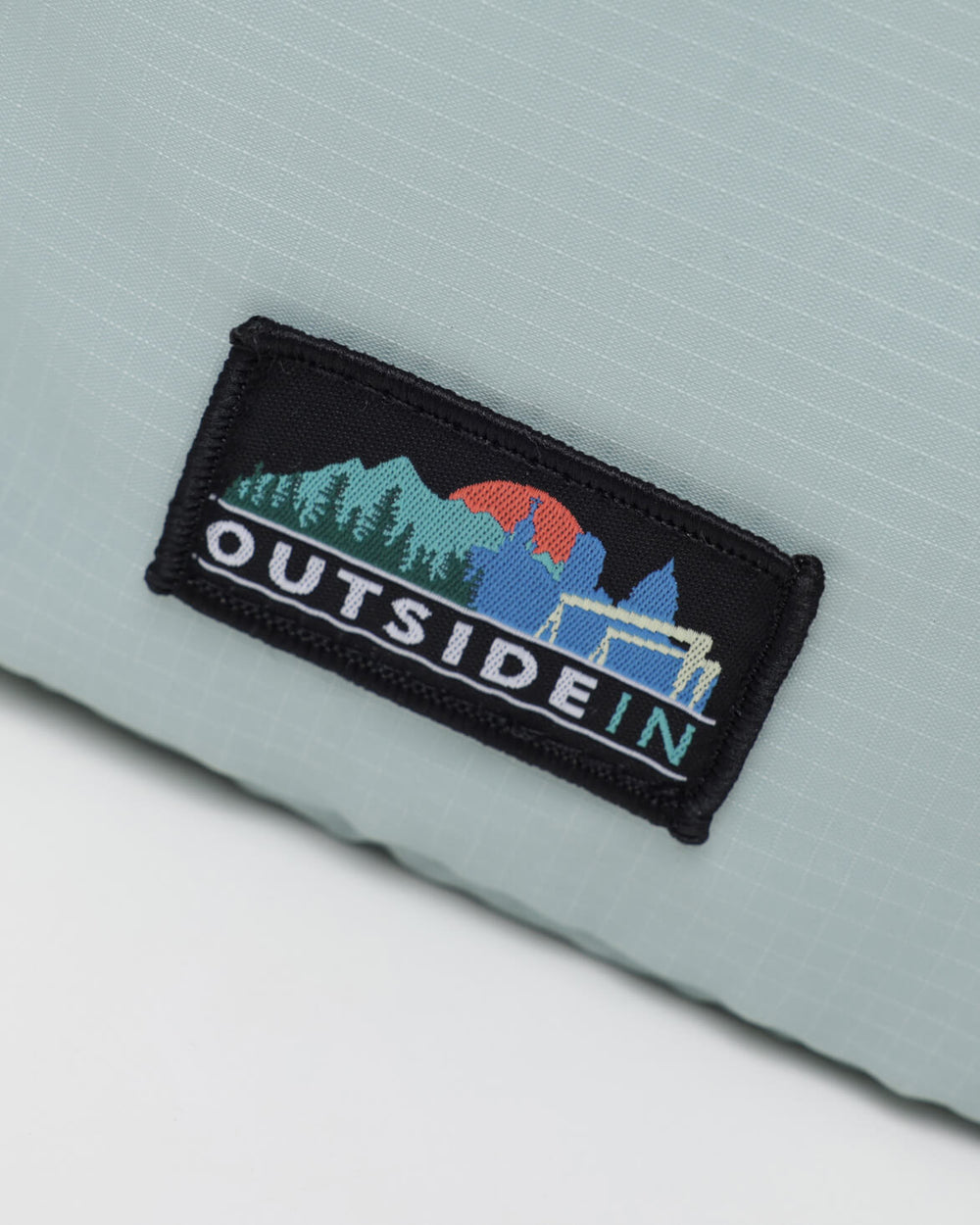 Close up of OutsideIn Light Green Lightweight Shoulder Pouch