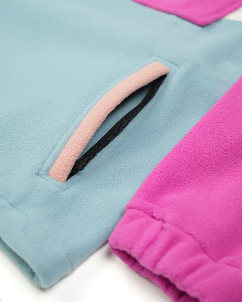 Unisex magenta cream fleece with quarter zip, front pocket and toggle detail