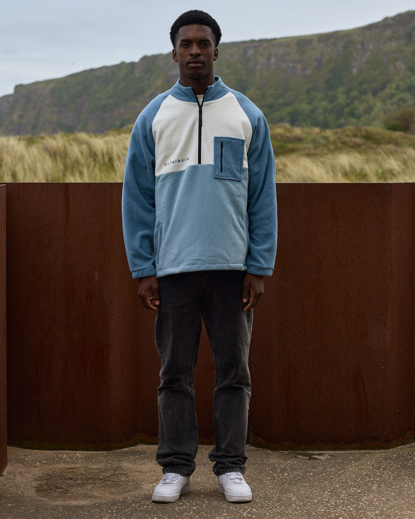 Unisex teal cream fleece with quarter zip, front pocket and toggle detail