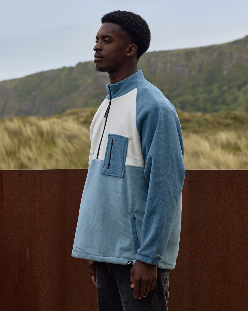 Unisex teal cream fleece with quarter zip, front pocket and toggle detail