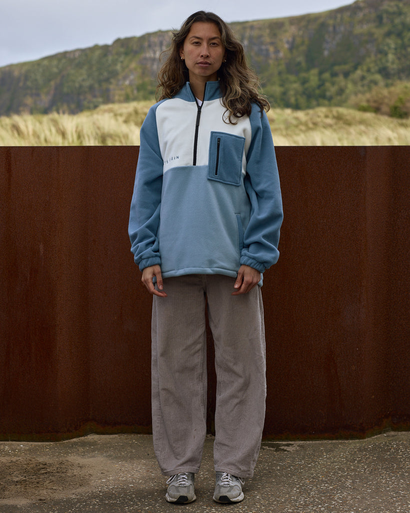 Unisex teal cream fleece with quarter zip, front pocket and toggle detail