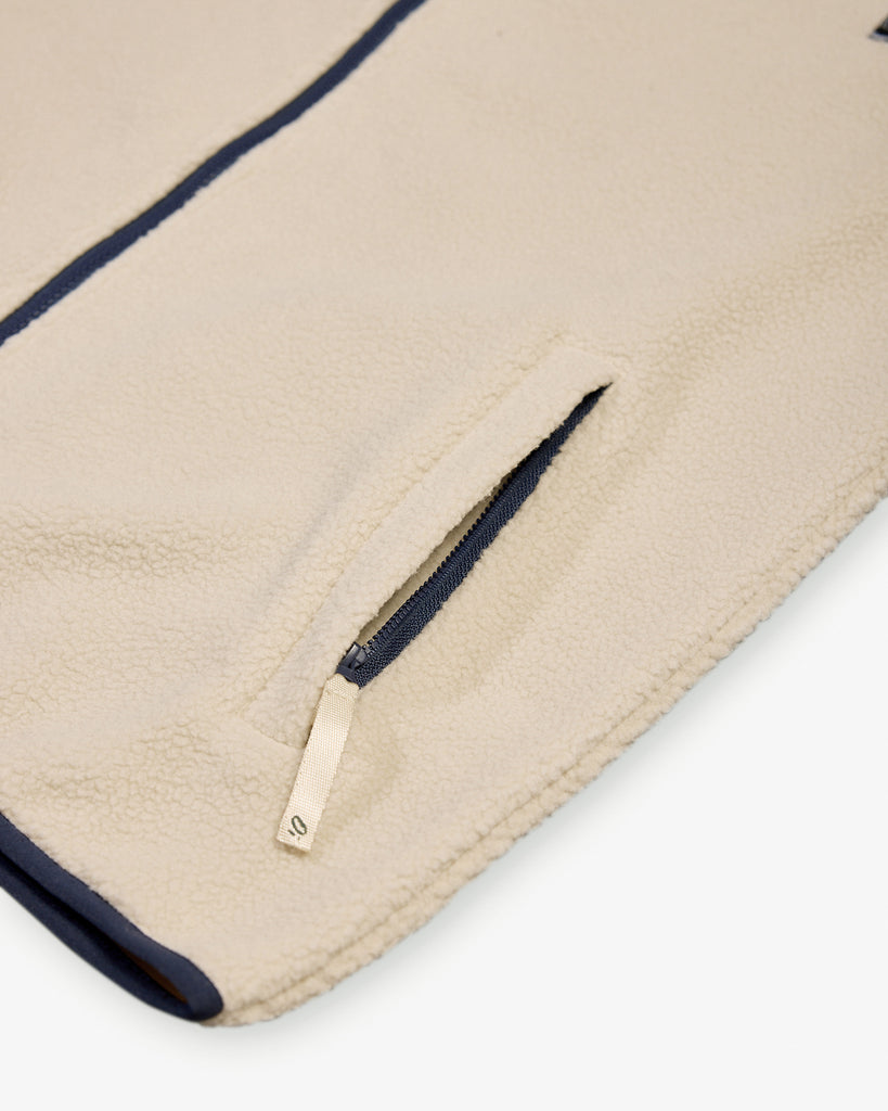 Oatmilk borg fleece with full zip, nylon contrast panels, and zip pockets