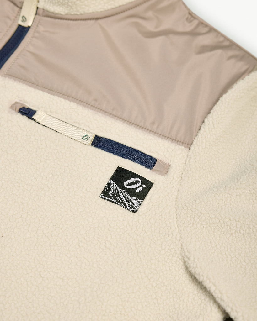 Oatmilk borg fleece with full zip, nylon contrast panels, and zip pockets